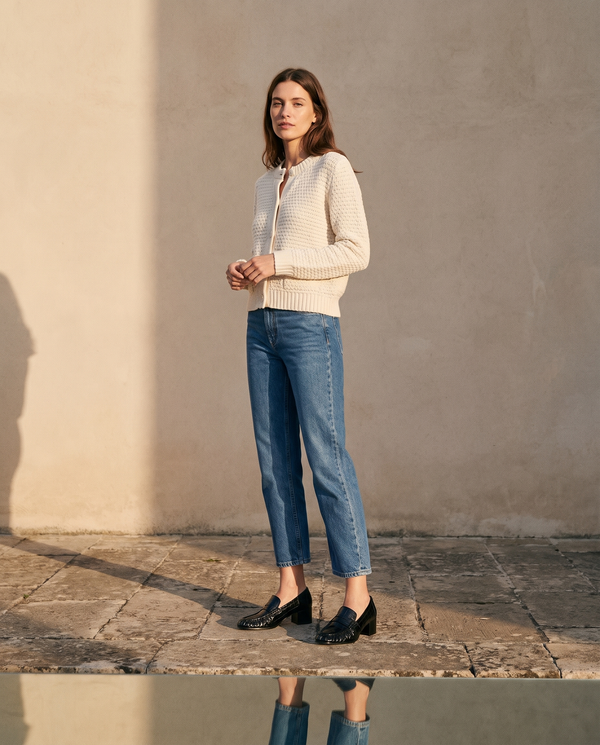Mocassins MARINE noirs portés avec un jean cropé sur une terrasse en pierre — A by André