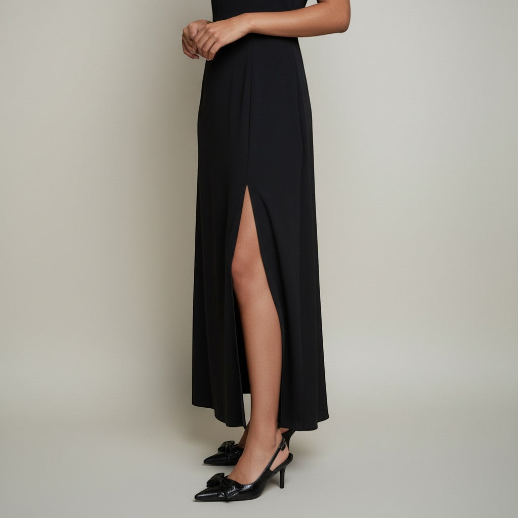 André Naya Noir black patent slingback heels with a large bow detail on the pointed toe.