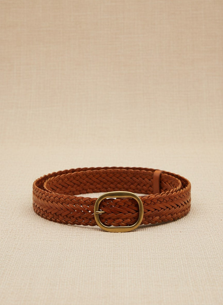 André Nerea camel braided genuine leather belt with antique gold buckle. Adjustable fit for a refined bohemian-chic style.
