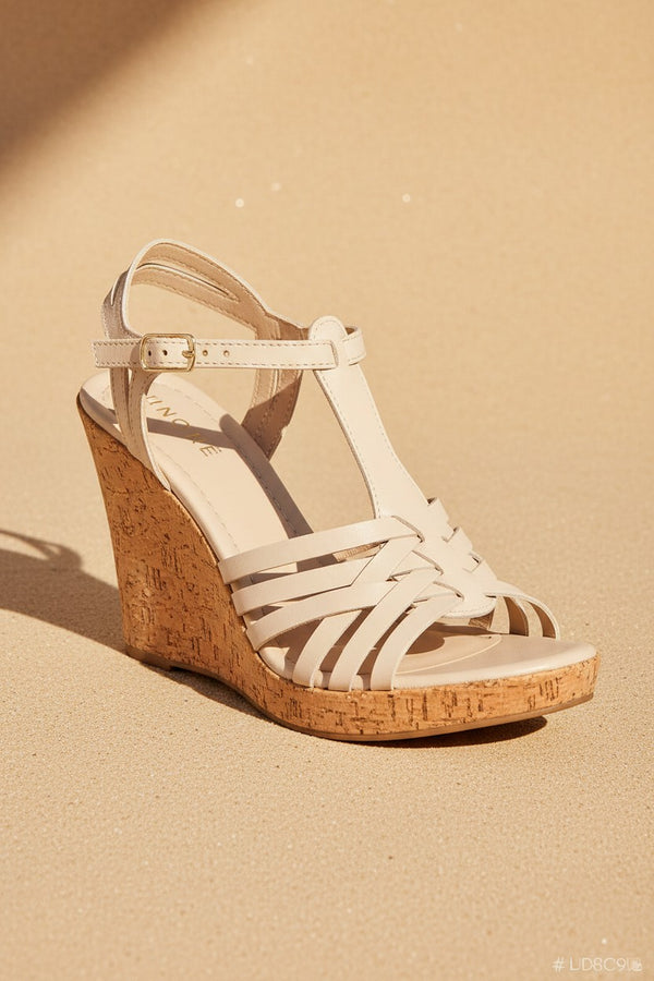 André sandales compensées beige en cuir tressé, semelle liège, bride cheville réglable, talon 9cm, fabriquées en Italie.