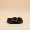 André Zestia cafe leather belt with ornate gold buckle. Deep brown, ideal for adding warmth to outfits.