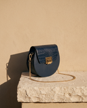 Sac CAROLYN bleu marine Maison André sur une marche en pierre