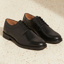 Chaussures derby noires en cuir lisse André, lacets, semelle robuste, idéales pour un look formel ou professionnel.