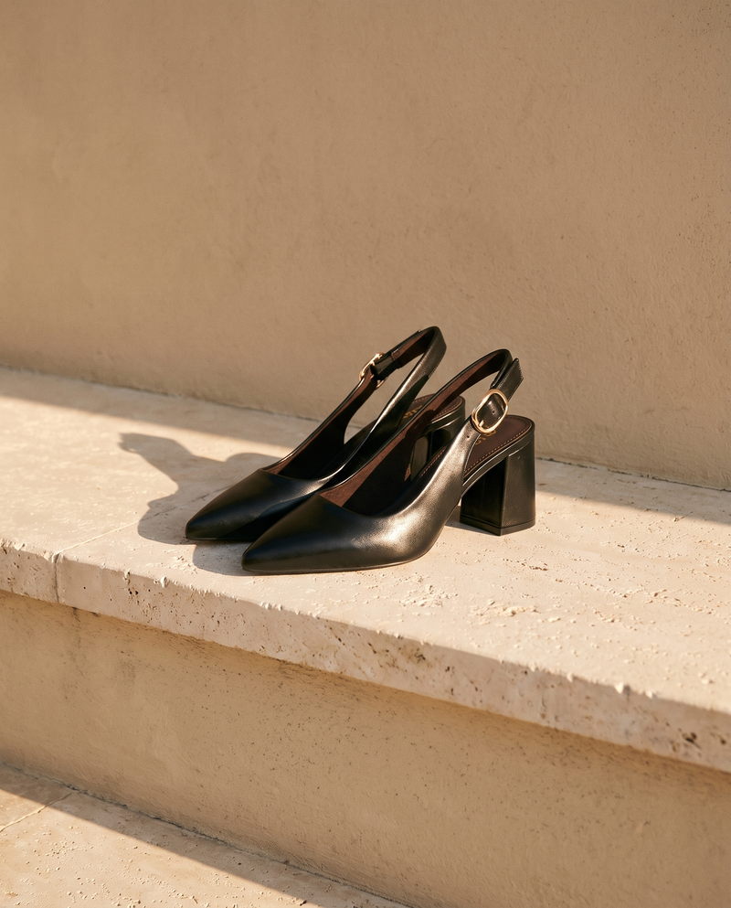 Paire de slingbacks THAÏS noirs posée sur une marche en pierre — A by André