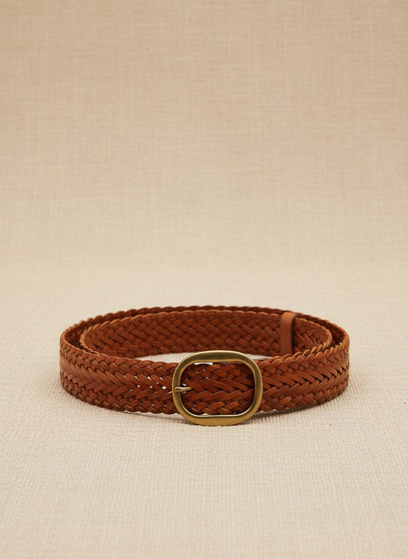 André Nerea camel braided genuine leather belt with antique gold buckle. Adjustable fit for a refined bohemian-chic style.