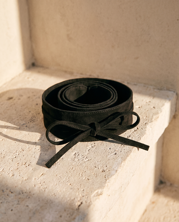 Ceinture SARAH noire à nœud enroulée sur une marche en pierre — A by André