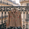 Chemise SIXTINE chocolat suspendue à une grille en fer, rue haussmannienne