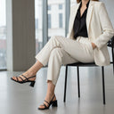André Tarsila Noir black patent leather sandals with thin straps and block heel.