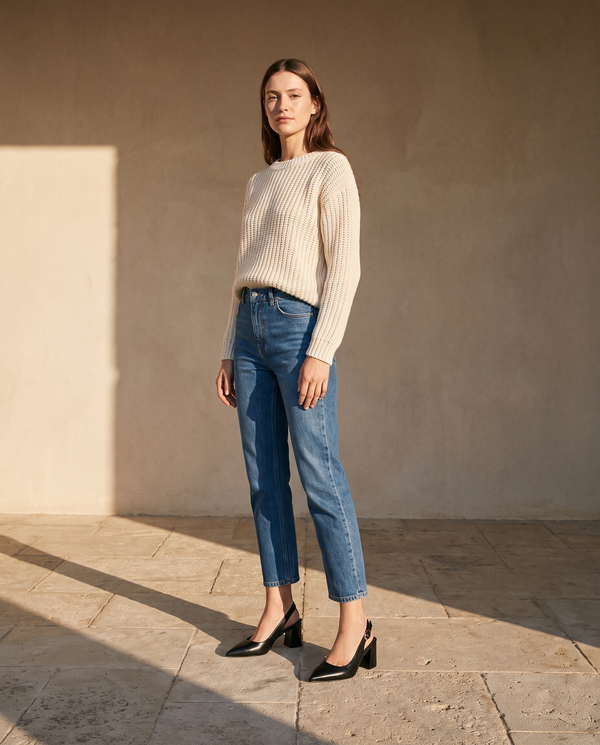 Slingbacks THAÏS noirs portés avec un jean cropé sur une terrasse en pierre — A by André